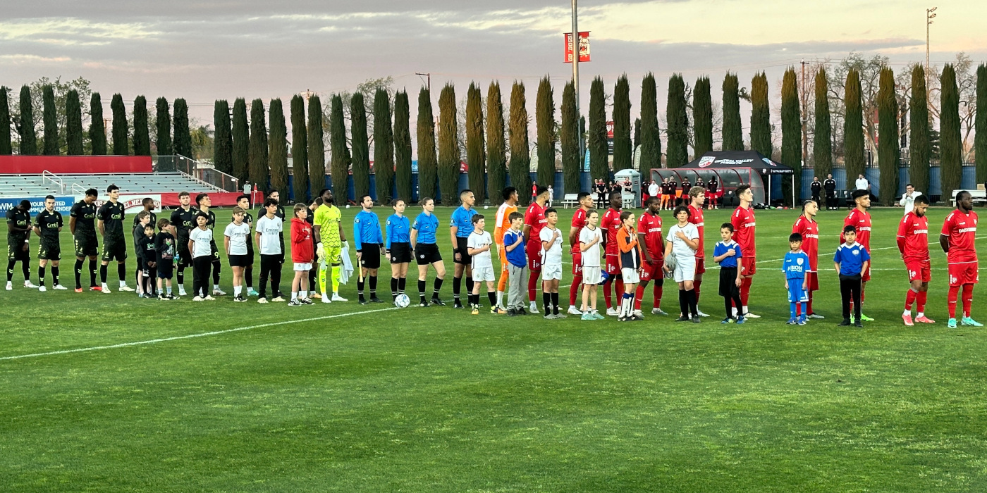 The Fresno Fuego and a local Fresno youth soccer team, the Fresno Havoc, line up before a game in Fresno State Soccer Stadium