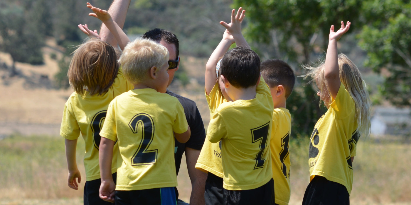 Little kids in Sanger asking a soccer coach a question