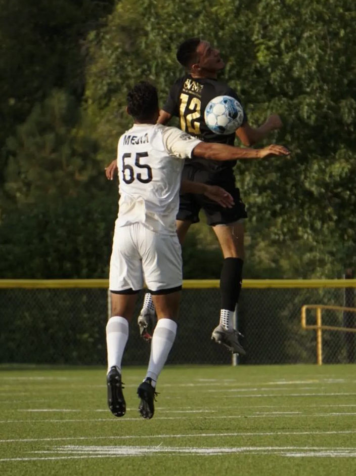 Valley 559 FC soccer players jump for a high soccer ball in Fresno during a match